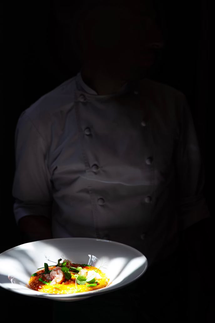 A chef presenting a finished plate
