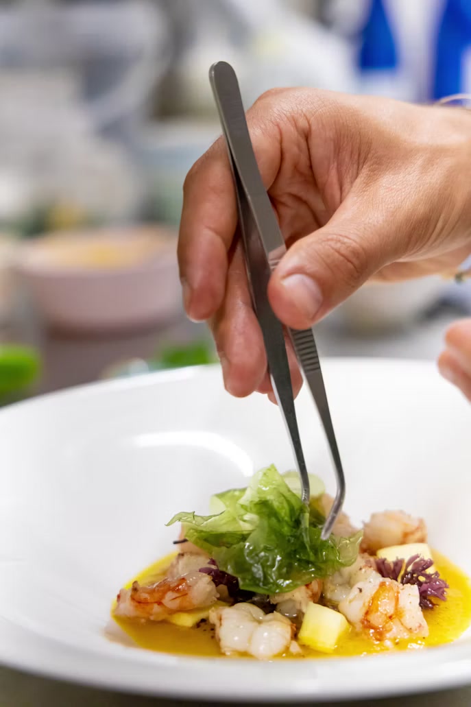 Chef adding a final garnish