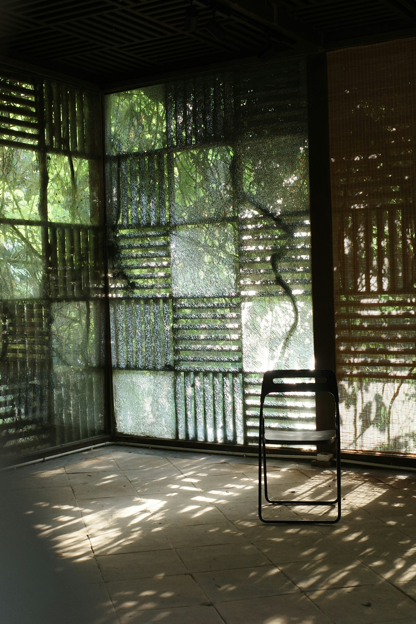 A quiet chair in patterned afternoon light